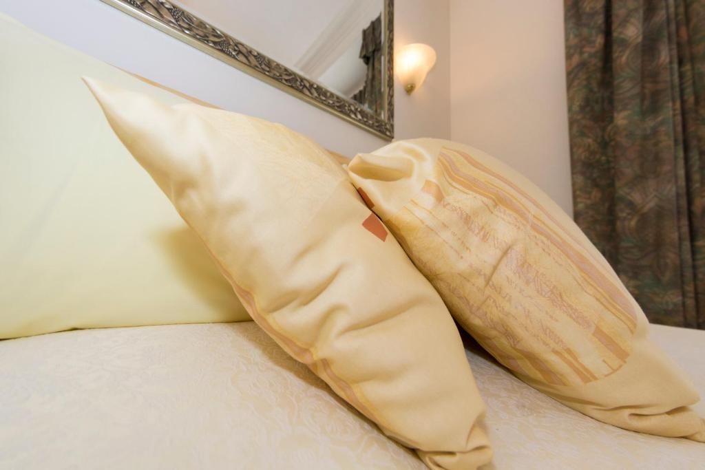 a pair of pillows sitting on top of a bed at Shoreline Accommodation in Bournemouth