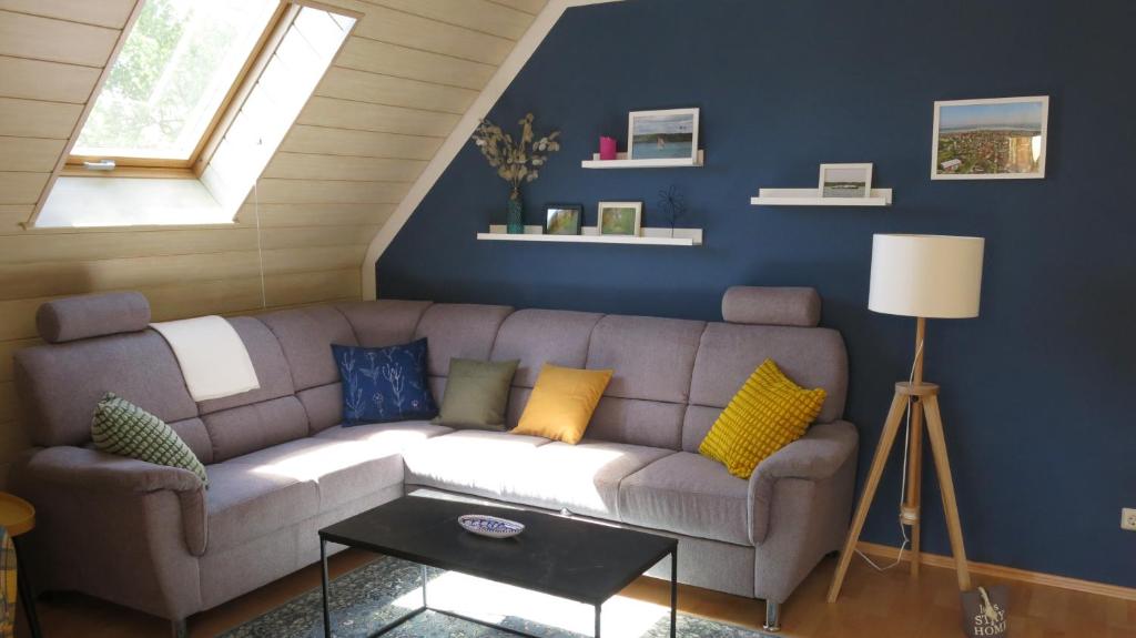 a living room with a couch and a window at Ferienwohnungen am Waldbad Zwenkau in Zwenkau