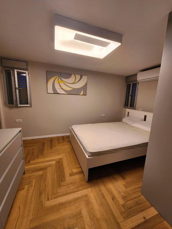 a bedroom with a bed and a skylight at Seaview Serenity in Nahariyya