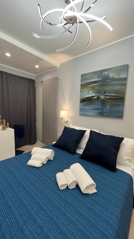 a large blue bed with two white pillows on it at LEDA Apartaments in Taormina