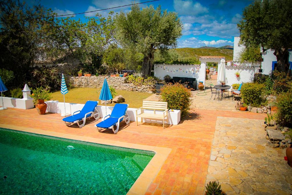 a patio with chairs and a swimming pool at Casa da Timenina Privates Rooms in São Brás de Alportel
