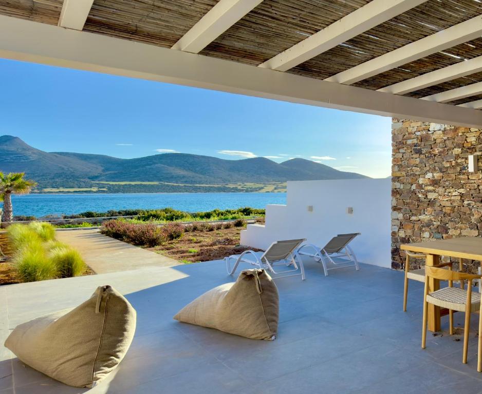 a dining room with a view of the water at Farous seaside sunset villa II in Antiparos