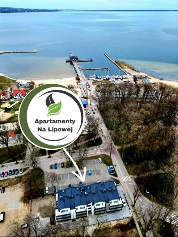 an aerial view of a parking lot with a sign at Apartamenty Lipowa in Puck