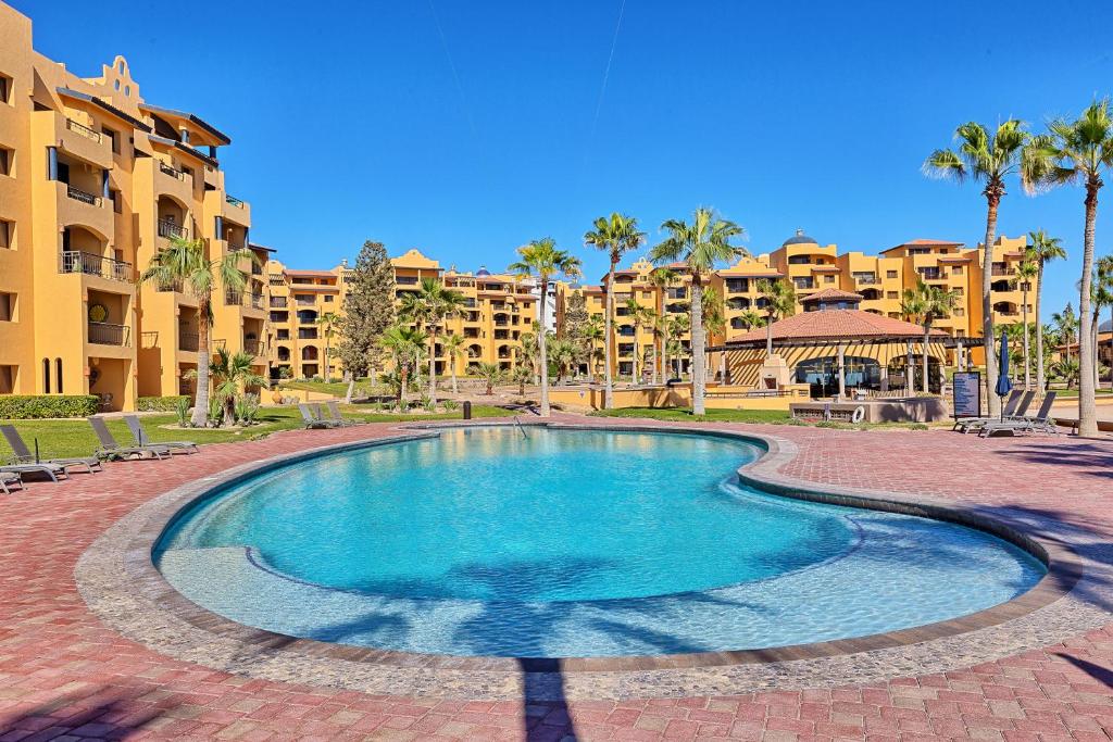 a swimming pool in front of a resort at Princesa De Penasco in Punta Penasco New