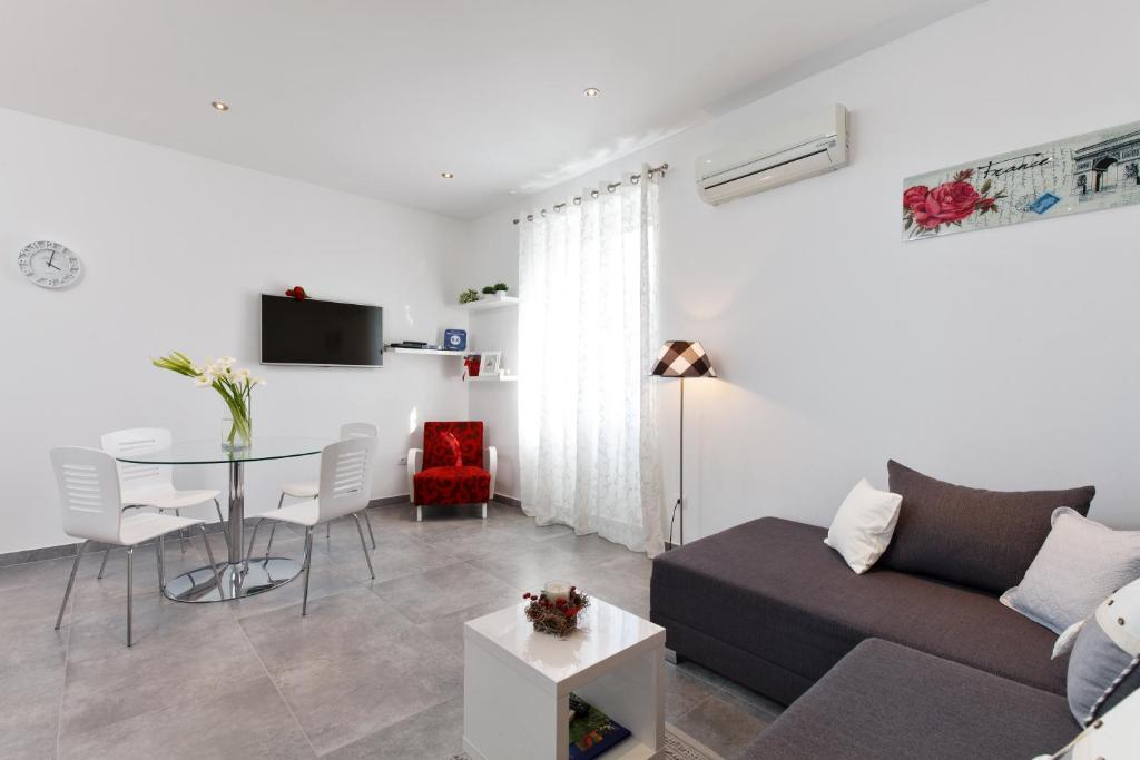 a living room with a couch and a table at Apartments Kala & Kaleta in Split