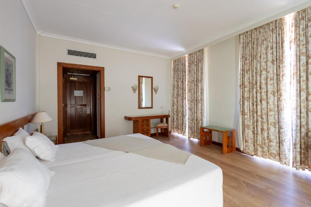 Postel nebo postele na pokoji v ubytování Hotel Universal
