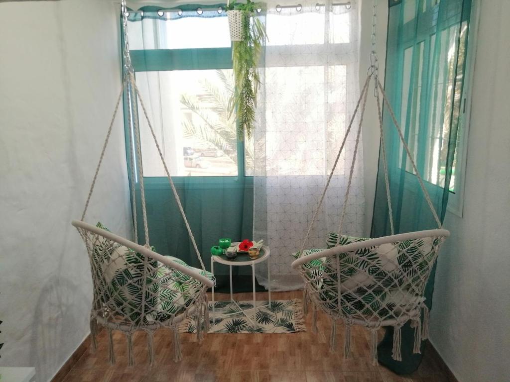 a room with two chairs and a table and a window at Casamaria in Tarajalejo