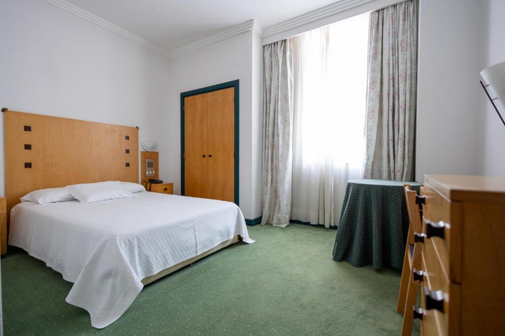 Postel nebo postele na pokoji v ubytování Hotel Das Termas