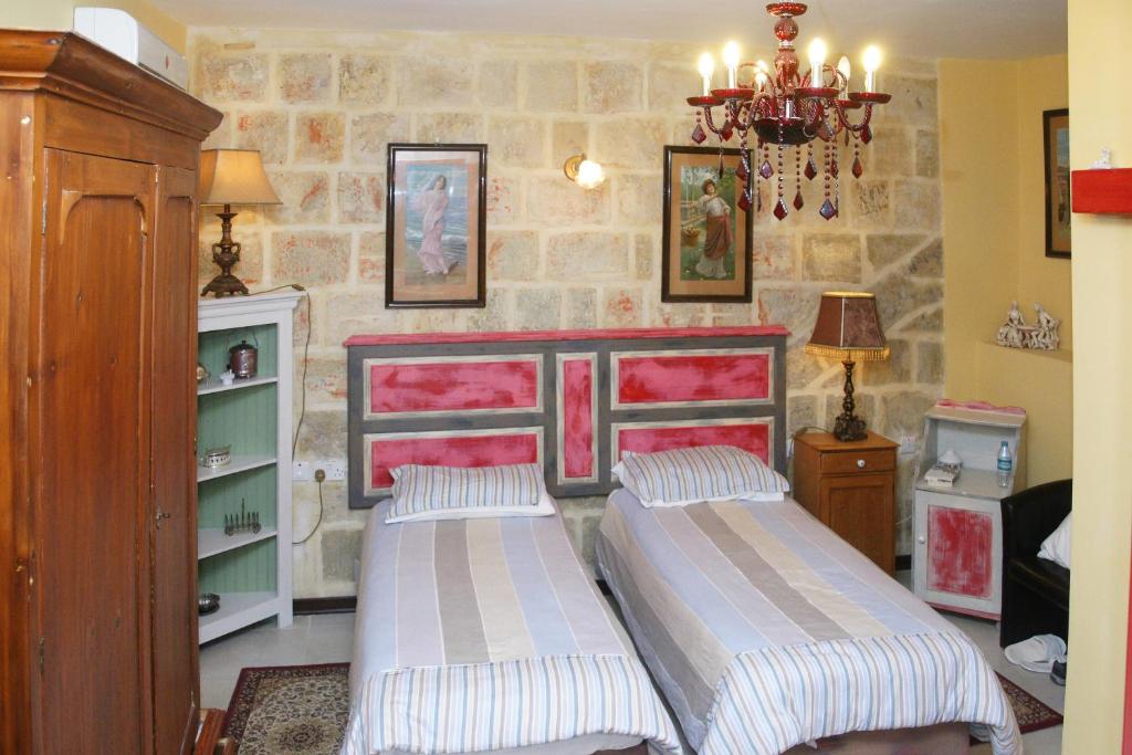 Postel nebo postele na pokoji v ubytování Luciano Valletta Boutique