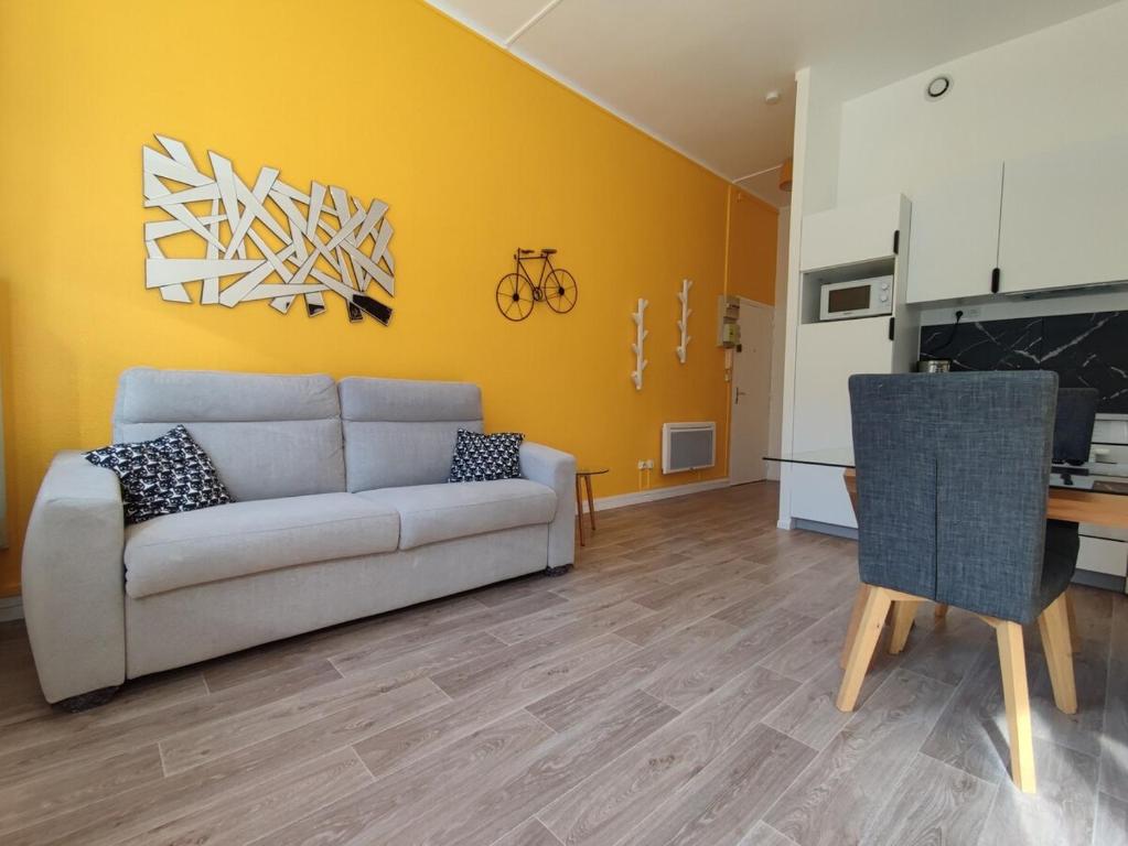 a living room with a couch and a table at TOK TOK S1 Appartement 1Ch Moderne Plein Centre in Seclin