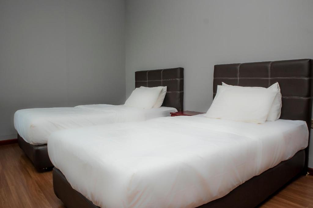 Postel nebo postele na pokoji v ubytování OYO 90059 Ltk Home