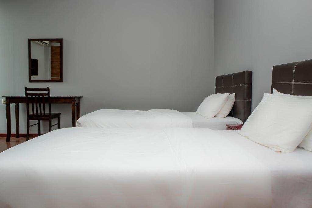 Postel nebo postele na pokoji v ubytování OYO 90059 Ltk Home