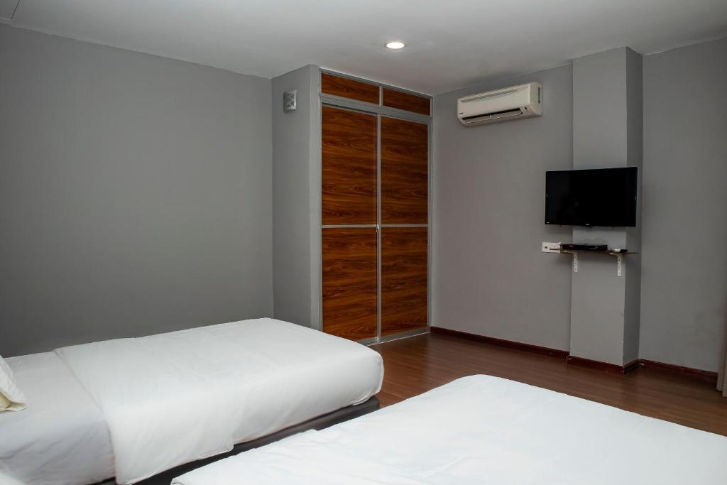 Postel nebo postele na pokoji v ubytování OYO 90059 Ltk Home