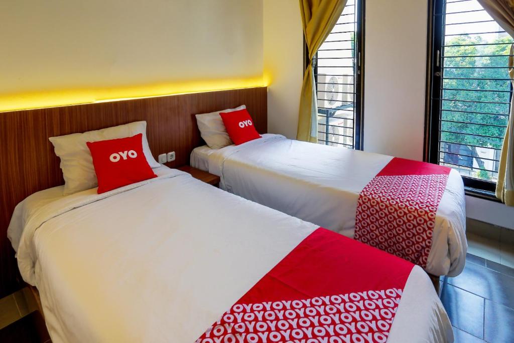 Postel nebo postele na pokoji v ubytování SUPER OYO 3109 Point Inn