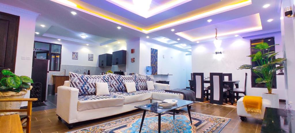 a living room with a couch and a table at Serene Hills Home in Nairobi