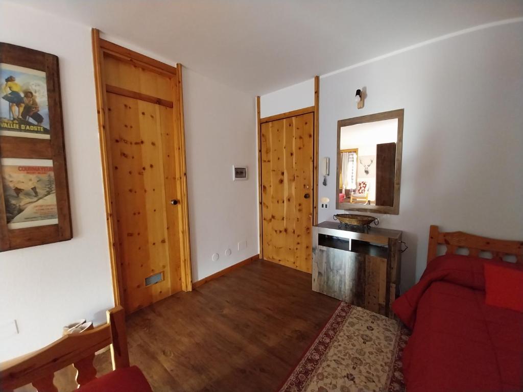 a living room with a red couch and a wooden door at Casa Cornella cir226 in Pila