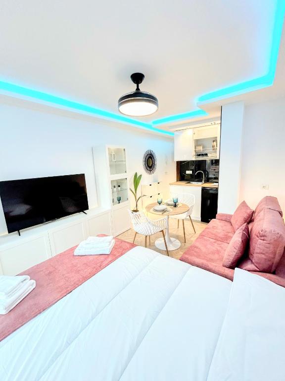 a large bedroom with a large bed and a table at Luxury studio Torremolinos Costa del Sol in Torremolinos