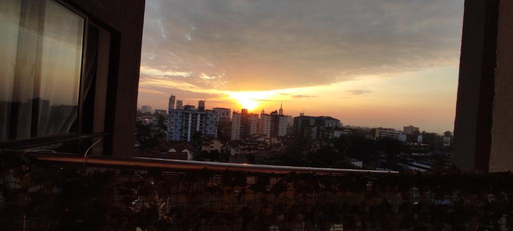 a sunset view from a window of a city at Serene Hills Home in Nairobi