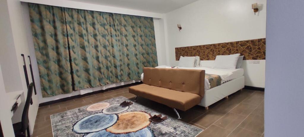 a hotel room with a bed and a chair at Serene Hills Home in Nairobi
