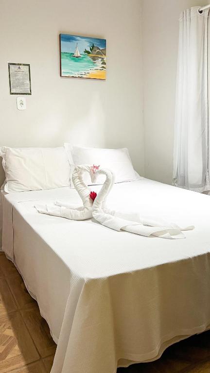 Ένα ή περισσότερα κρεβάτια σε δωμάτιο στο Pousada e Hostel Caraíva Flor