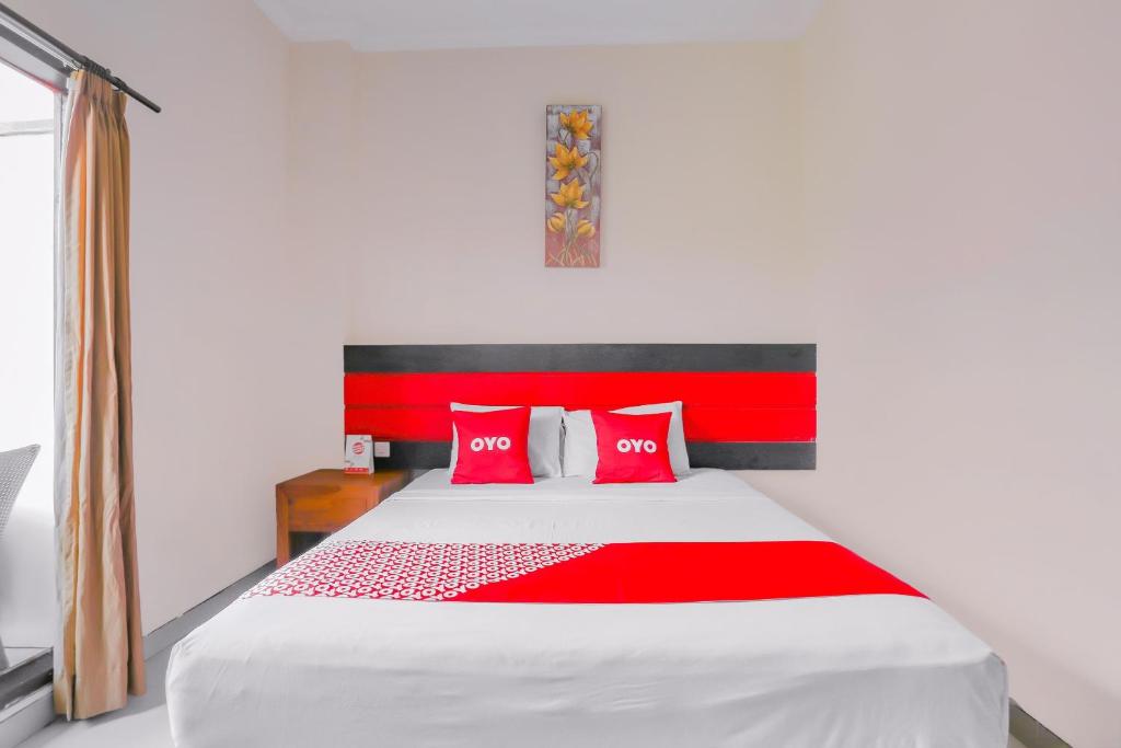 Postel nebo postele na pokoji v ubytování OYO 4012 Ari Beach Inn