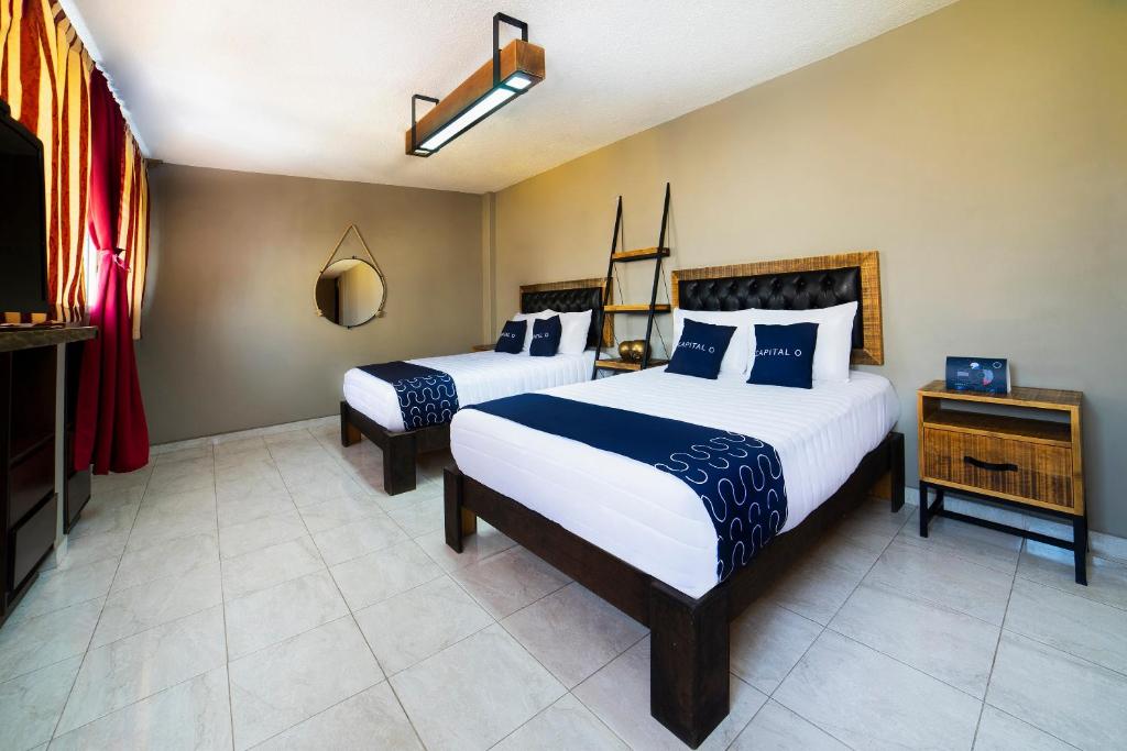 Postel nebo postele na pokoji v ubytování Capital O Hotel Diez