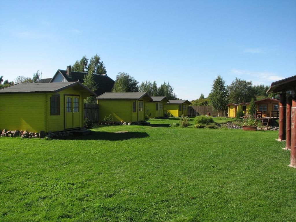 a yard with a row of small houses at Kolkja Holiday Centre in Kolkja