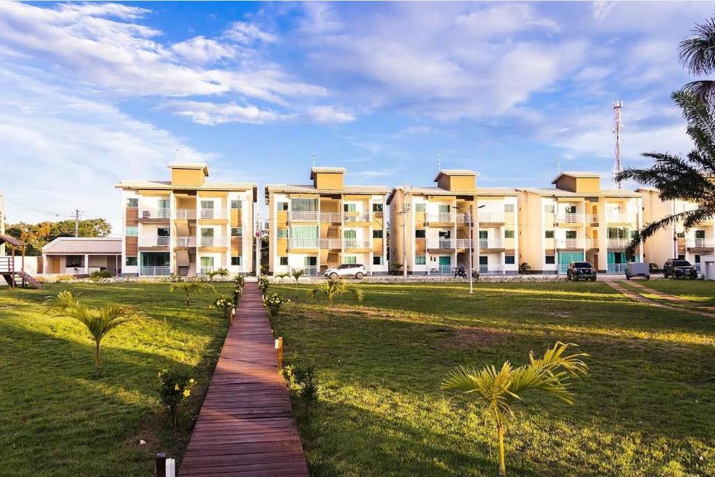 a large building with a pathway in front of it at Apartamento Beira-Rio in Barreirinhas