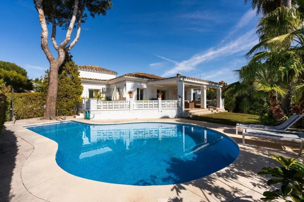 a swimming pool in front of a house at Villa Roco Marbella private pool and sea view in Marbella