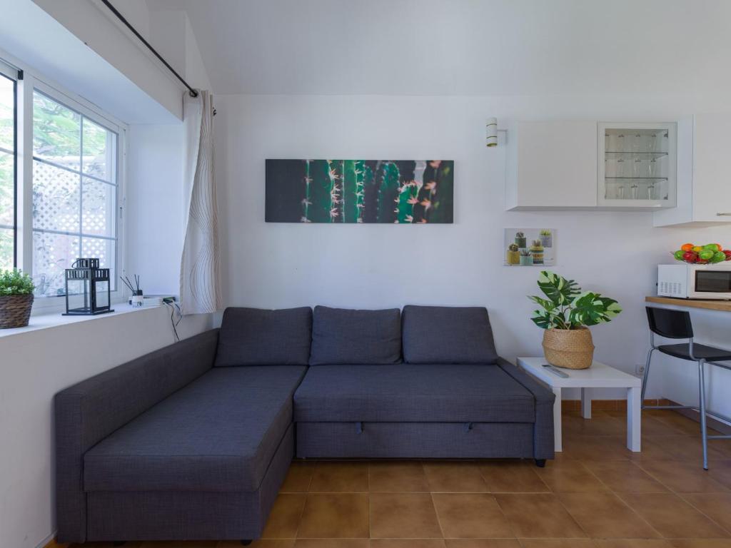 a living room with a couch and a table at Bungalow in Maspalomas near Golf & Beach in San Bartolomé de Tirajana