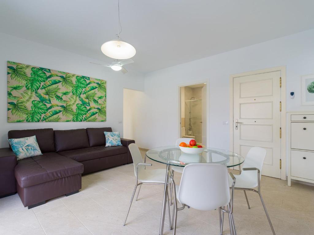 a living room with a couch and a glass table at Apartment in Mogán Playa near the Beach in Mogán