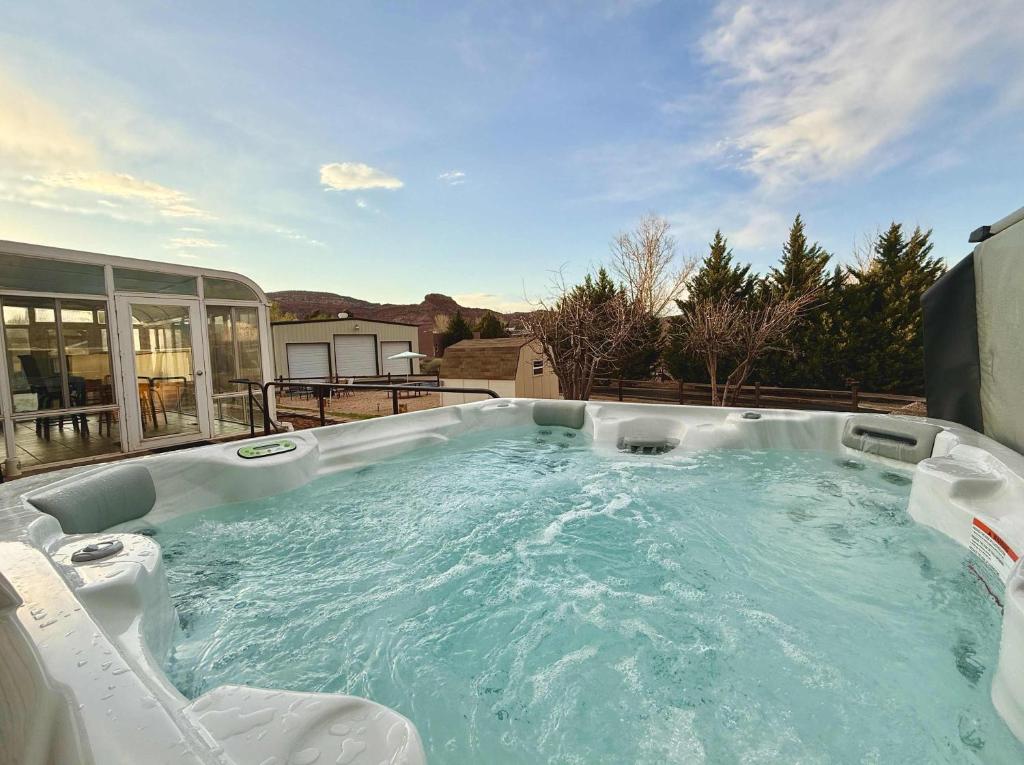 a jacuzzi tub with two chairs sitting in it at Home near Zion with private hot tub Sleeps 10 in Kanab