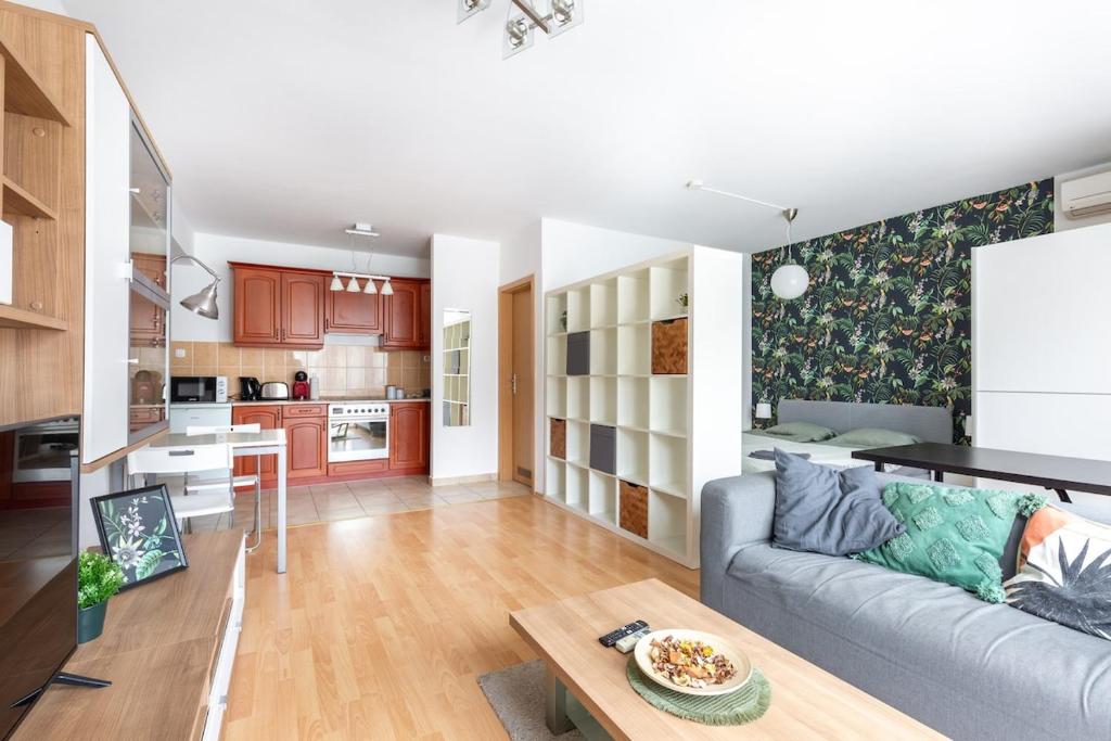 Una sala de estar y una cocina con un sofá y una mesa. en ER14 Erkel utca 14 A - lovely studio with terrace, en Budapest