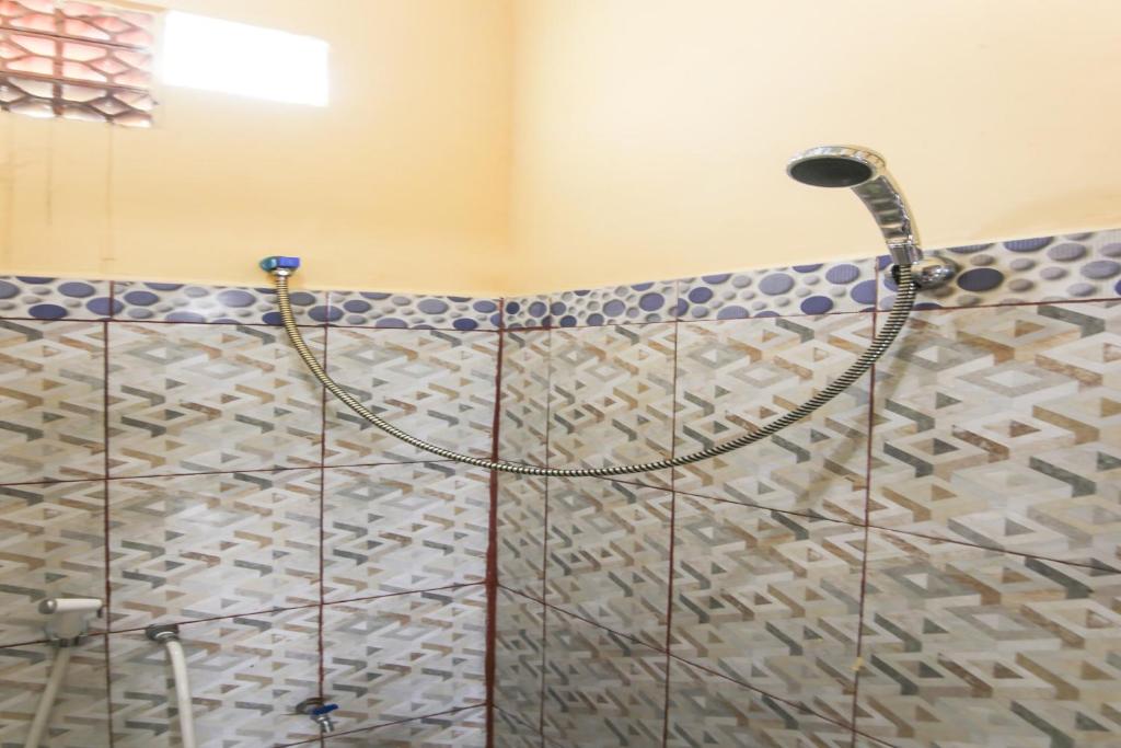 a shower in a bathroom with a glass door at OYO Life 90433 Serasi Kost in Palembang