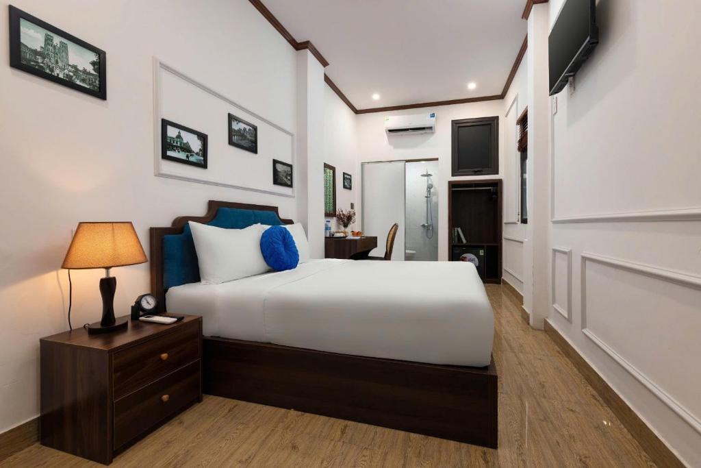 Postel nebo postele na pokoji v ubytování The Ambery Hanoi Boutique Hotel & Travel