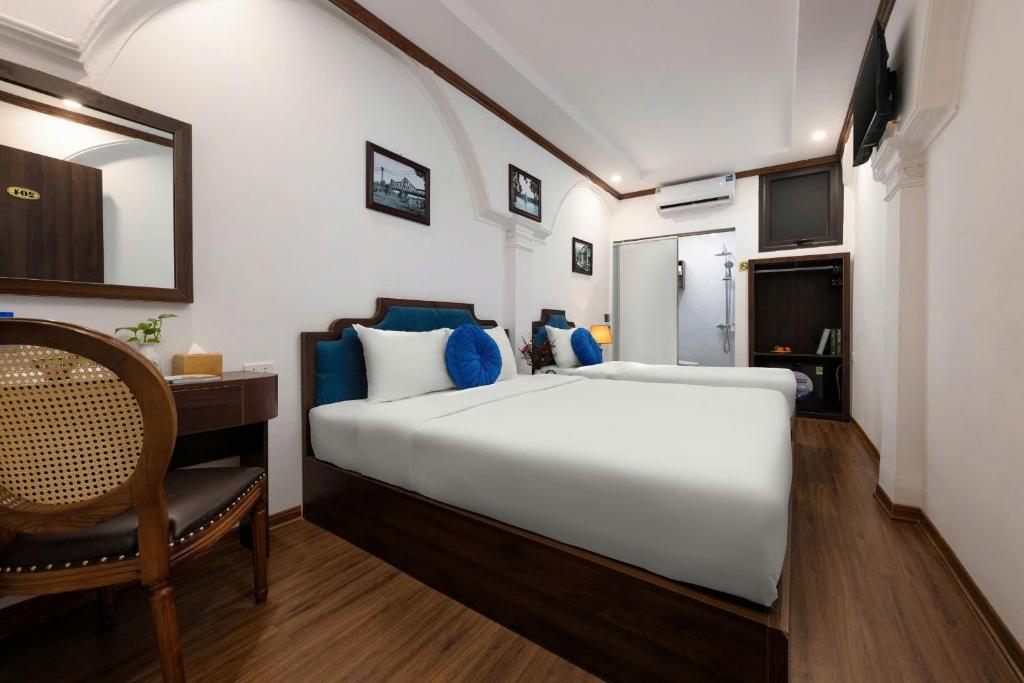 Postel nebo postele na pokoji v ubytování The Ambery Hanoi Boutique Hotel & Travel