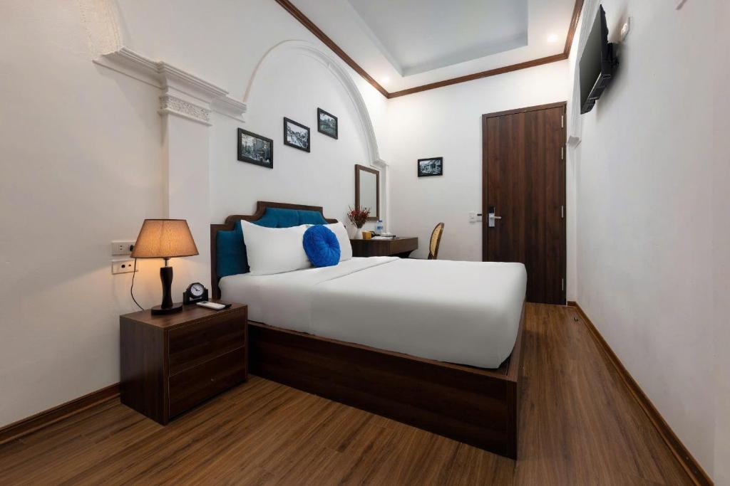 Postel nebo postele na pokoji v ubytování The Ambery Hanoi Boutique Hotel & Travel