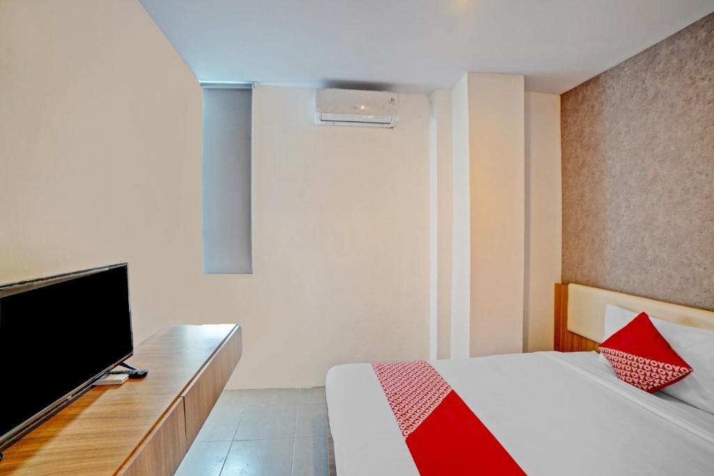 Postel nebo postele na pokoji v ubytování Super OYO 90559 Gamacity Residence