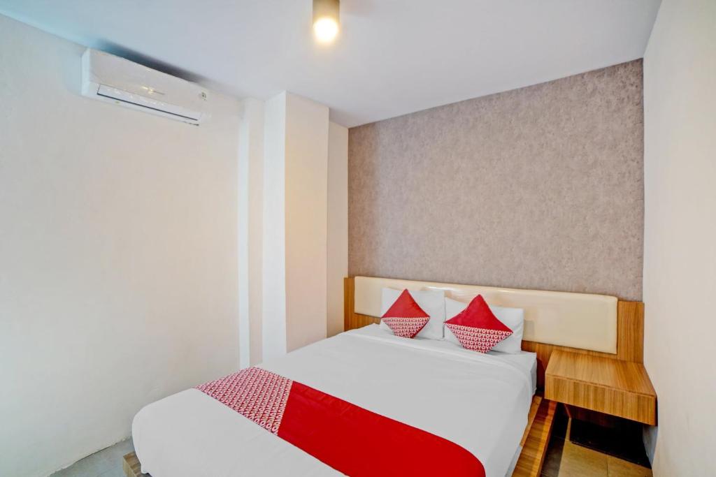Postel nebo postele na pokoji v ubytování Super OYO 90559 Gamacity Residence