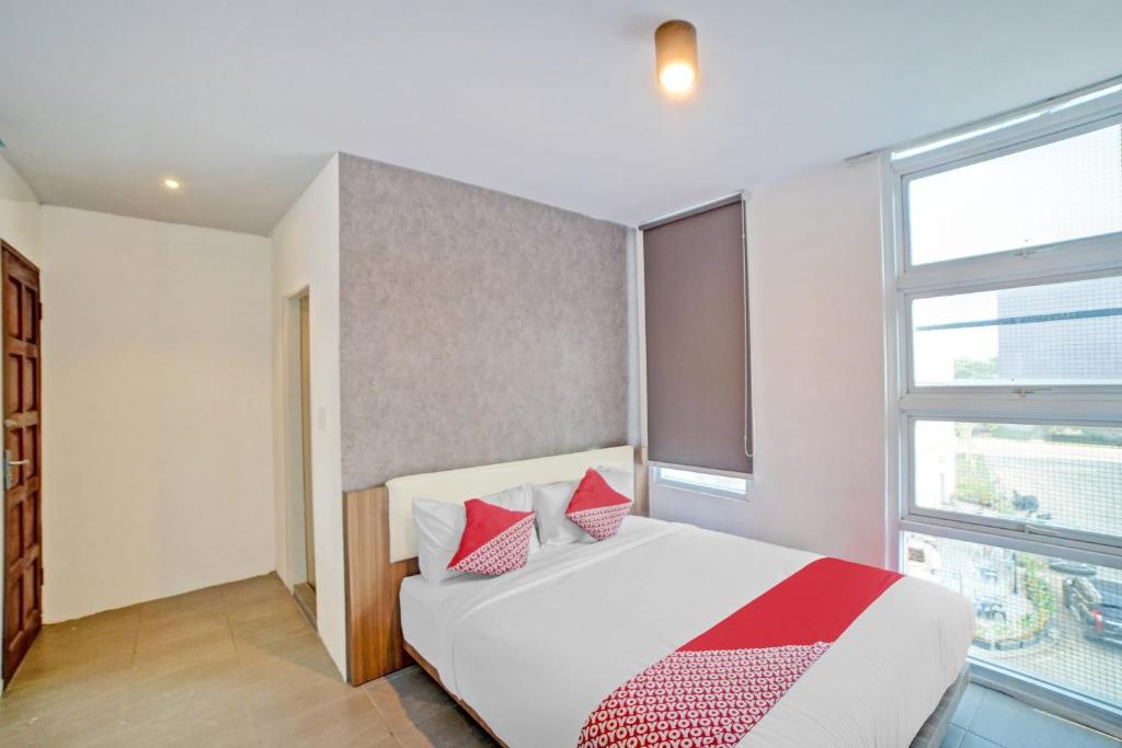 Postel nebo postele na pokoji v ubytování Super OYO 90559 Gamacity Residence