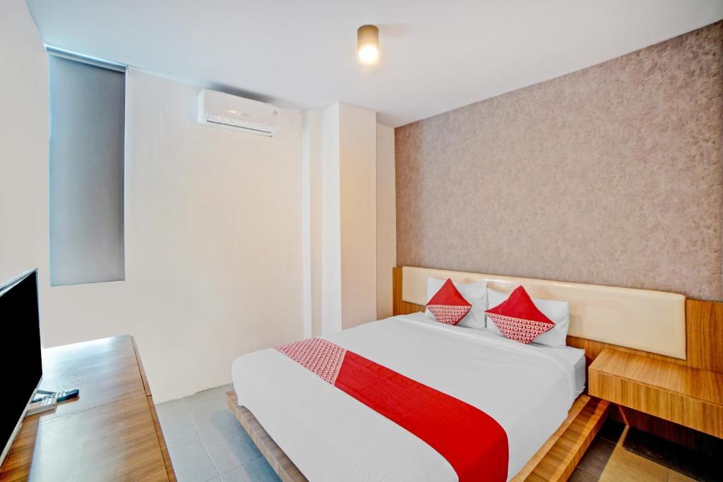 Postel nebo postele na pokoji v ubytování Super OYO 90559 Gamacity Residence