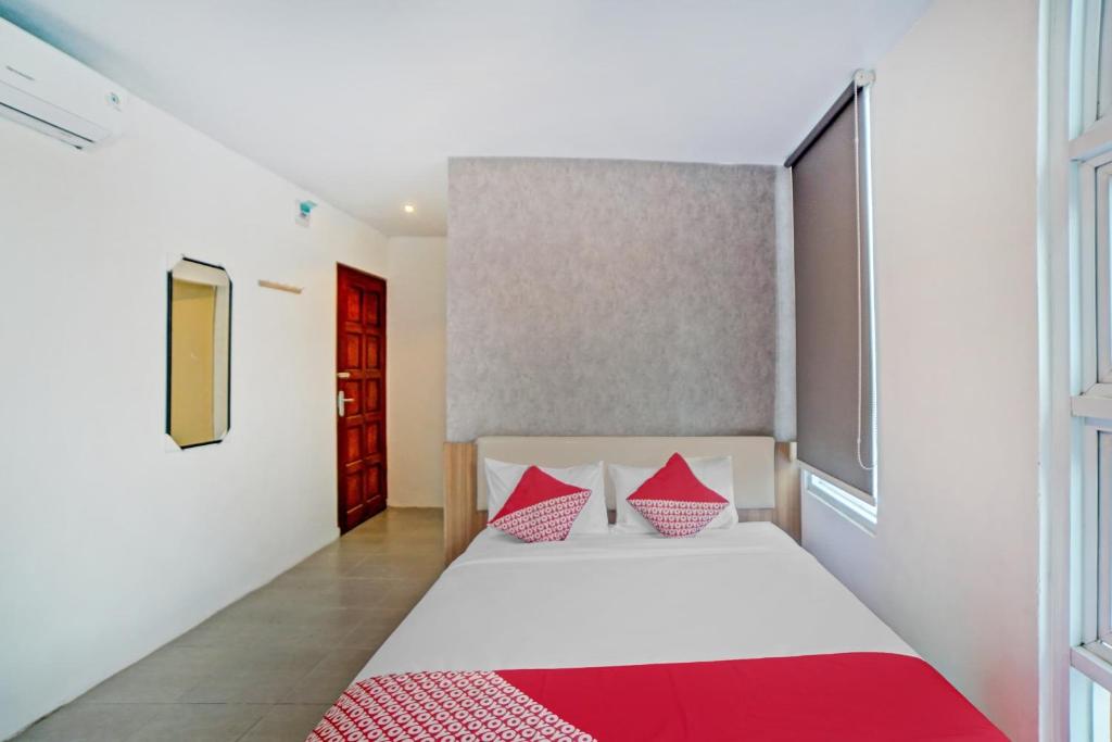 Postel nebo postele na pokoji v ubytování Super OYO 90559 Gamacity Residence