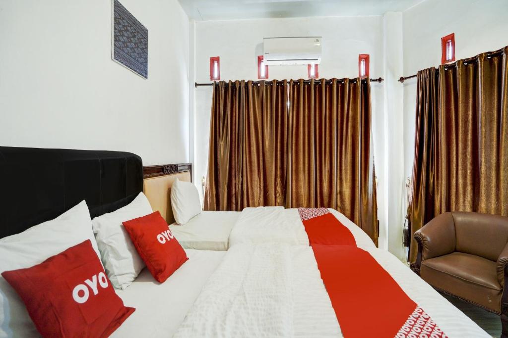 Postel nebo postele na pokoji v ubytování OYO 90645 Karisma Residence