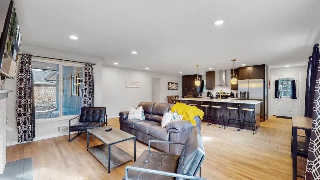 a living room with a couch and a kitchen at Spacious Family Retreat in Denver in Denver