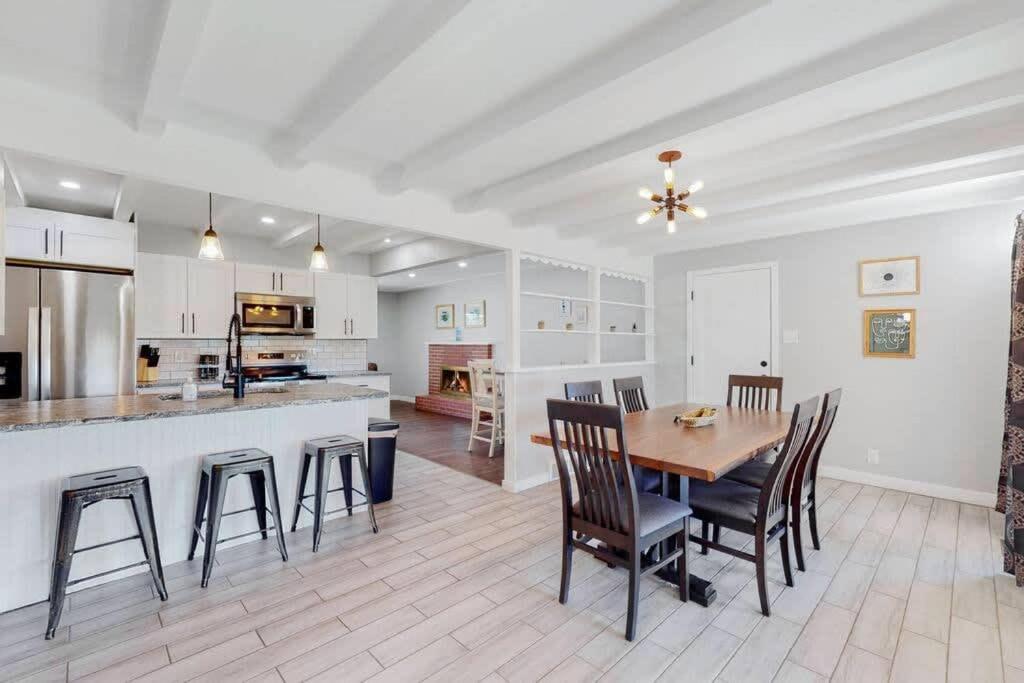 a kitchen and dining room with a table and chairs at Stunning Upper Family Unit with King Beds & Yard in Denver
