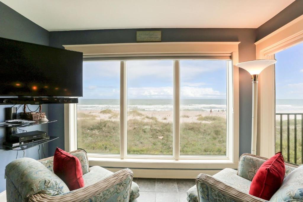 a living room with a large window with a view of the ocean at Oceans Of Amelia - 105 in Fernandina Beach