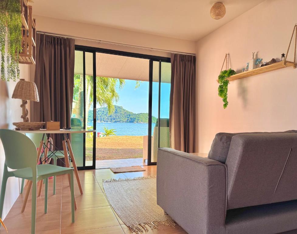 a living room with a couch and a glass table at Secret Place in Panwa Beach
