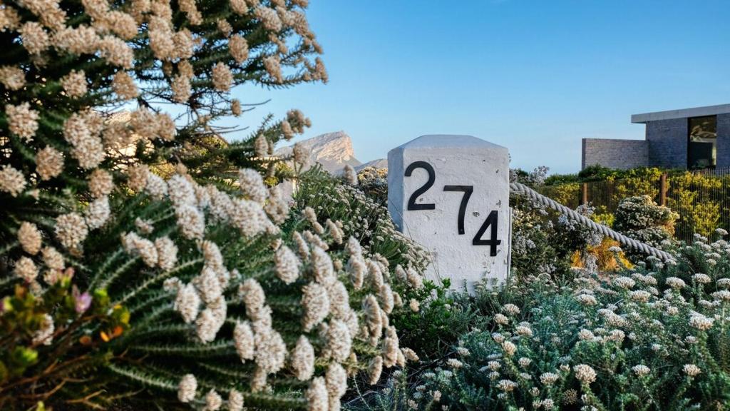 a sign with the number on it next to plants at Klein-Hangklip Remote Mountain Studio Cottage in Rooiels