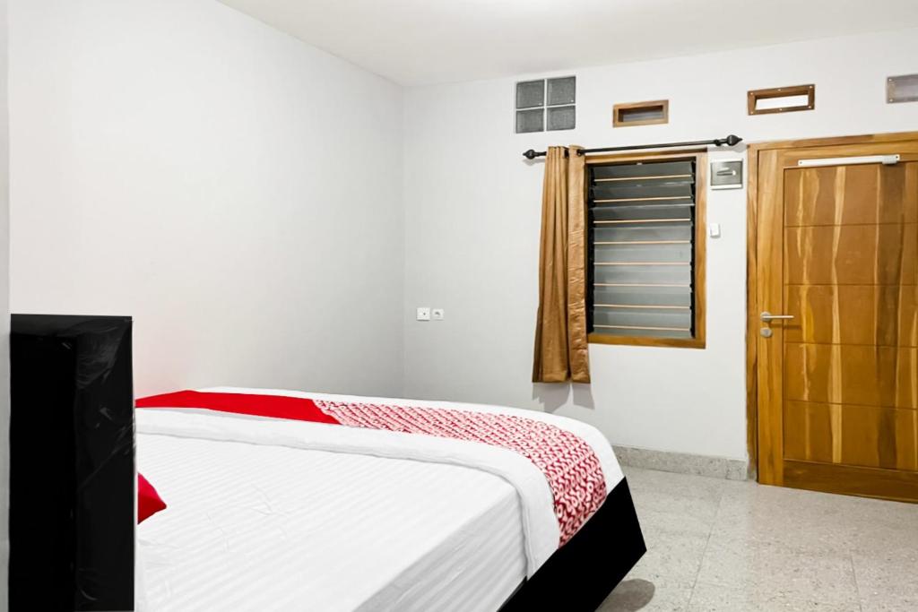Postel nebo postele na pokoji v ubytování OYO 90708 Kbr Home