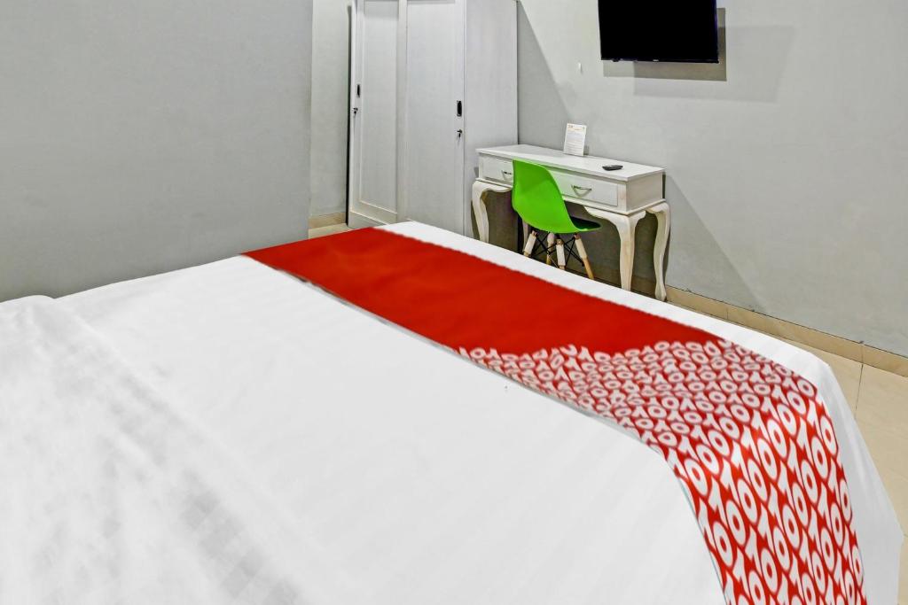 Postel nebo postele na pokoji v ubytování Super OYO 90767 Gm Guest House